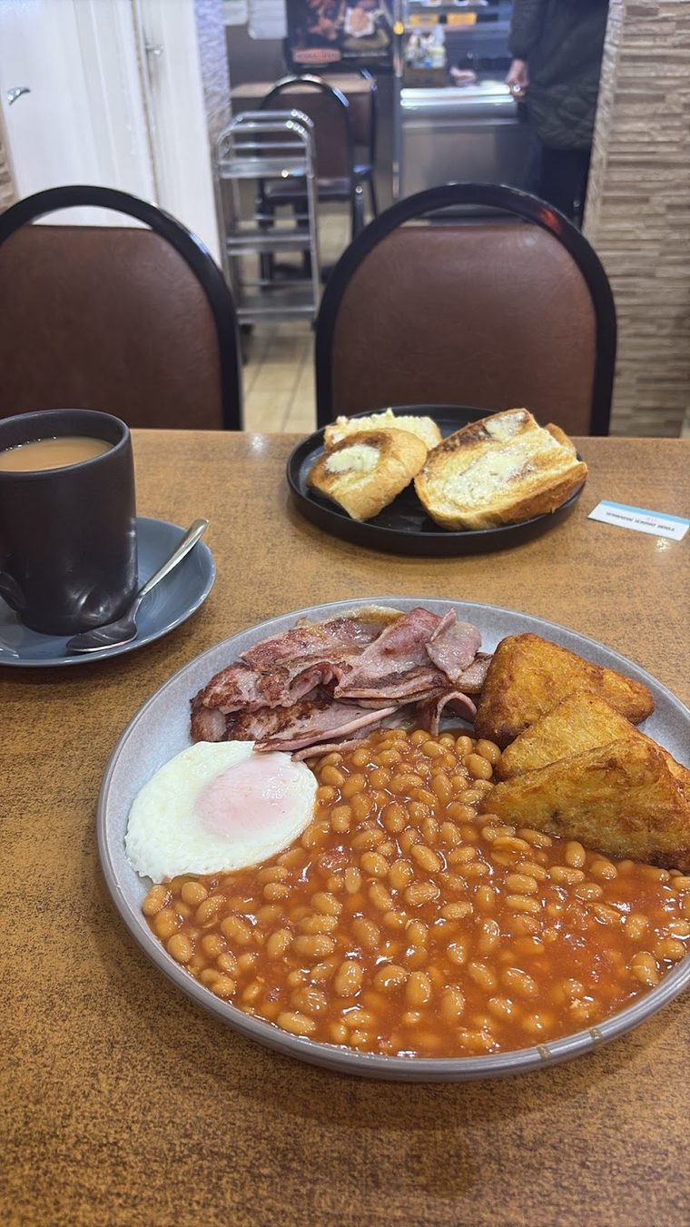 A full English breakfast of beans, bacon, egg and hash browns with toast and coffee